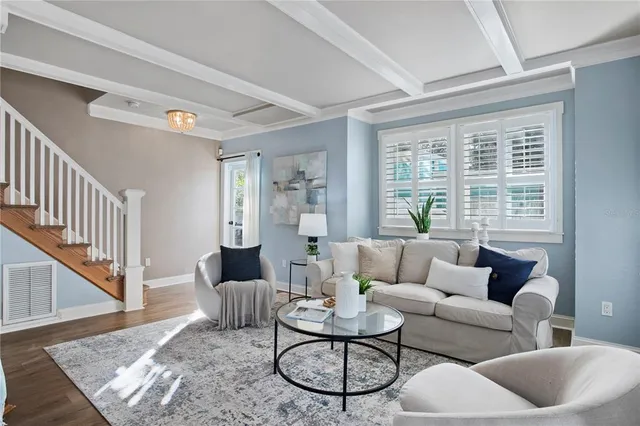 a living room with furniture and a potted plant