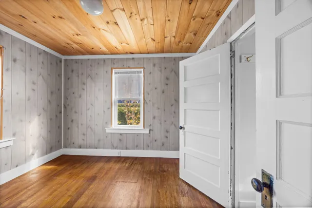 a view of a livingroom with wooden floor and window