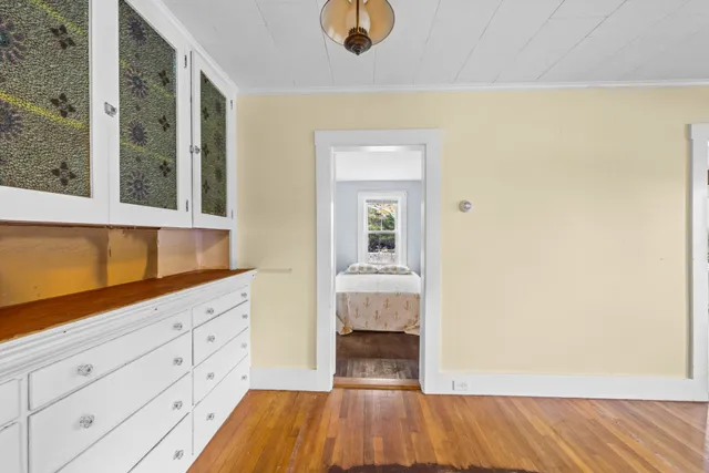 a view of kitchen and hall with wooden floor