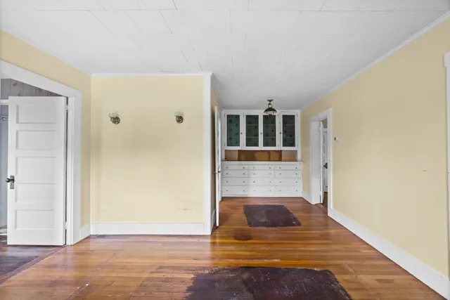 a view of a bedroom with wooden floor