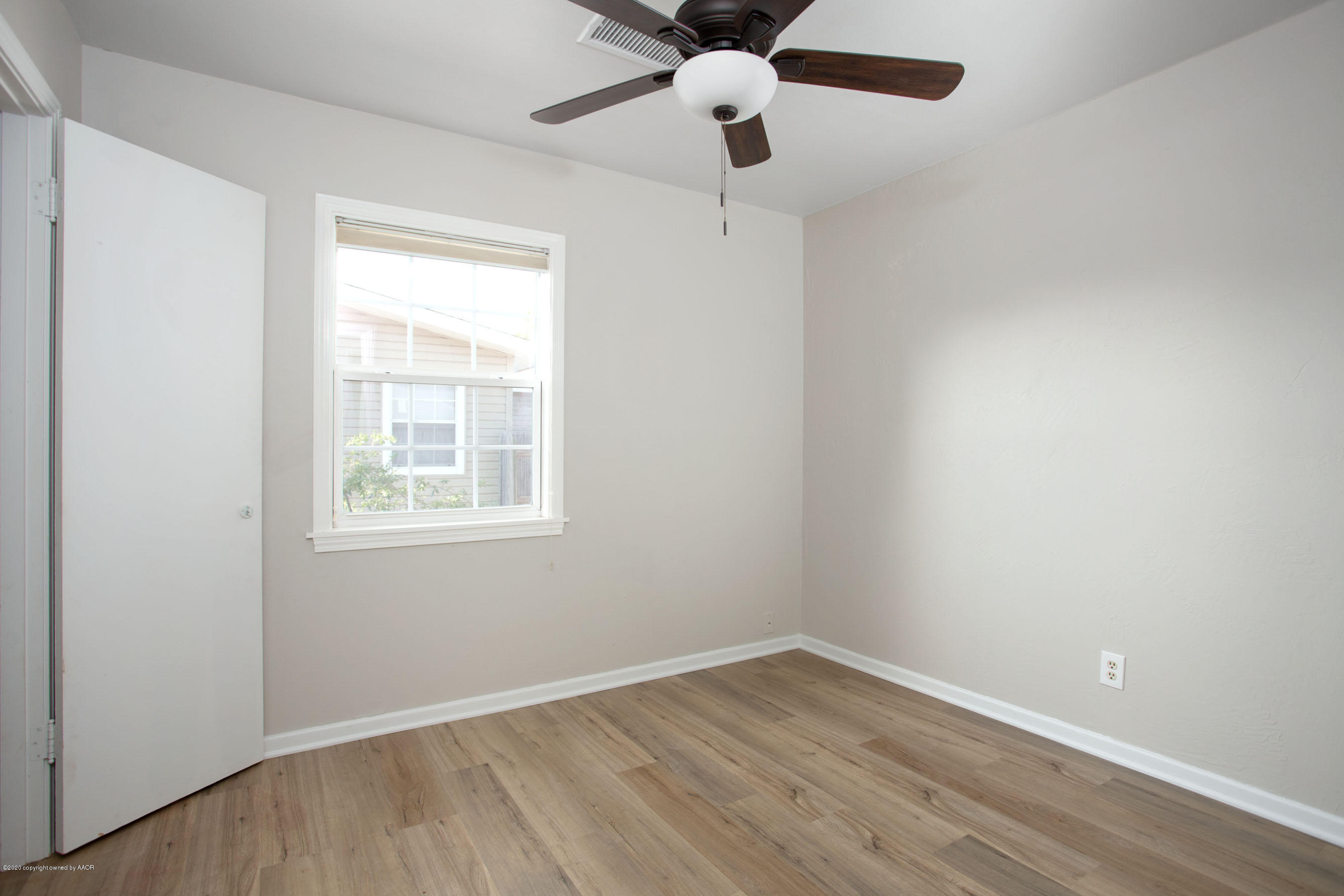 4302 South Lipscomb Street Amarillo, TX 79110 - Photo 12 of 16 an empty room with a window and a ceiling fan