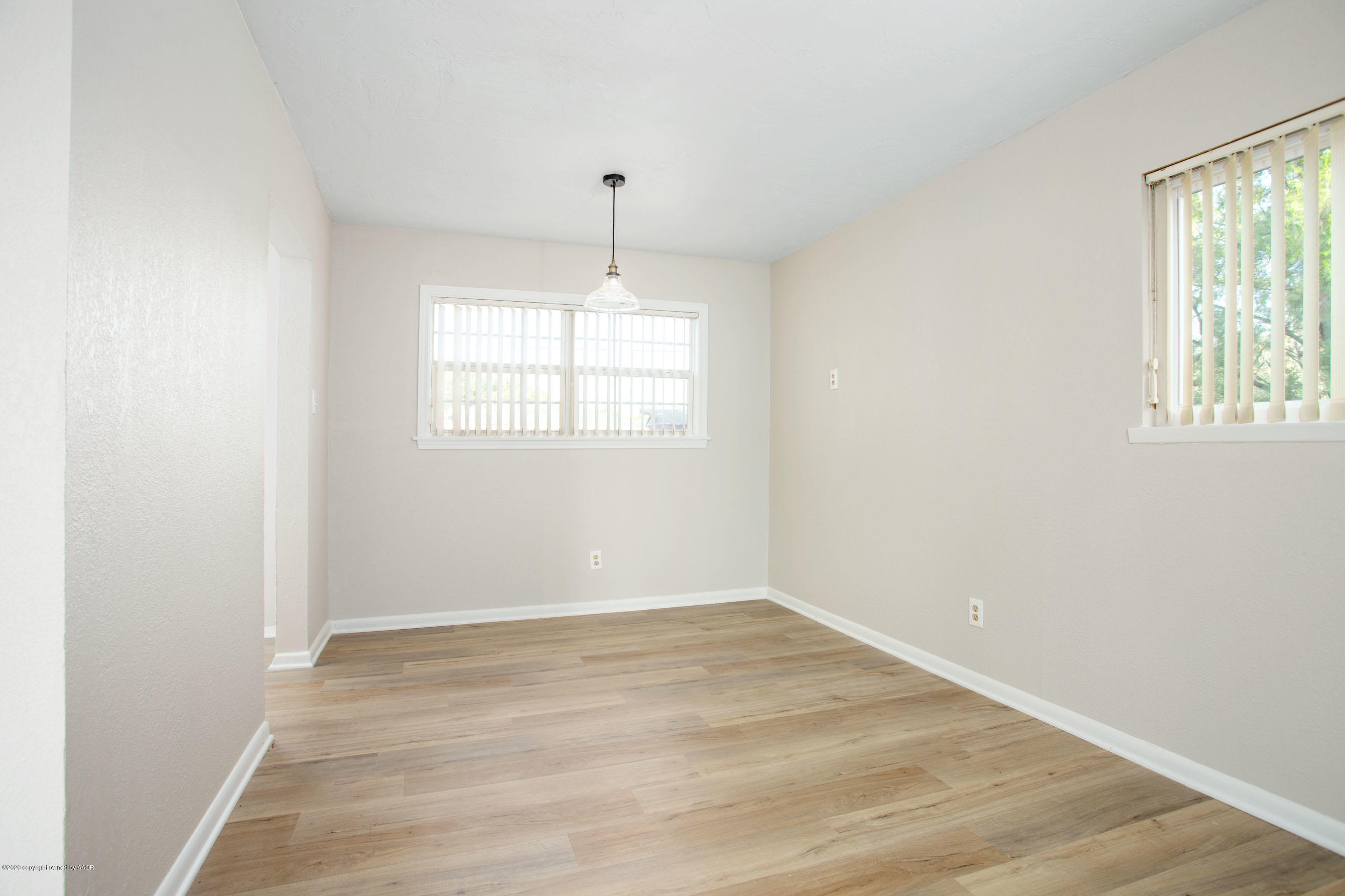 4302 South Lipscomb Street Amarillo, TX 79110 - Photo 8 of 16 an empty room with wooden floor and windows