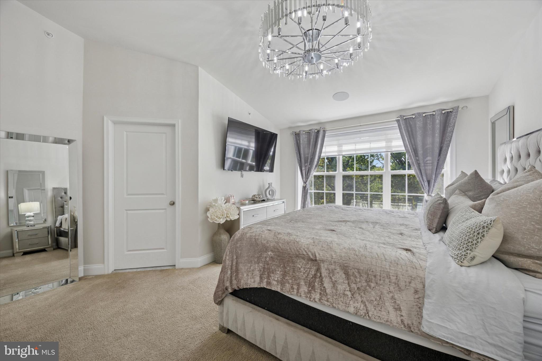 213 Corvus Circle Media, PA 19063 - Photo 14 of 34 a bedroom with a large bed and a chandelier