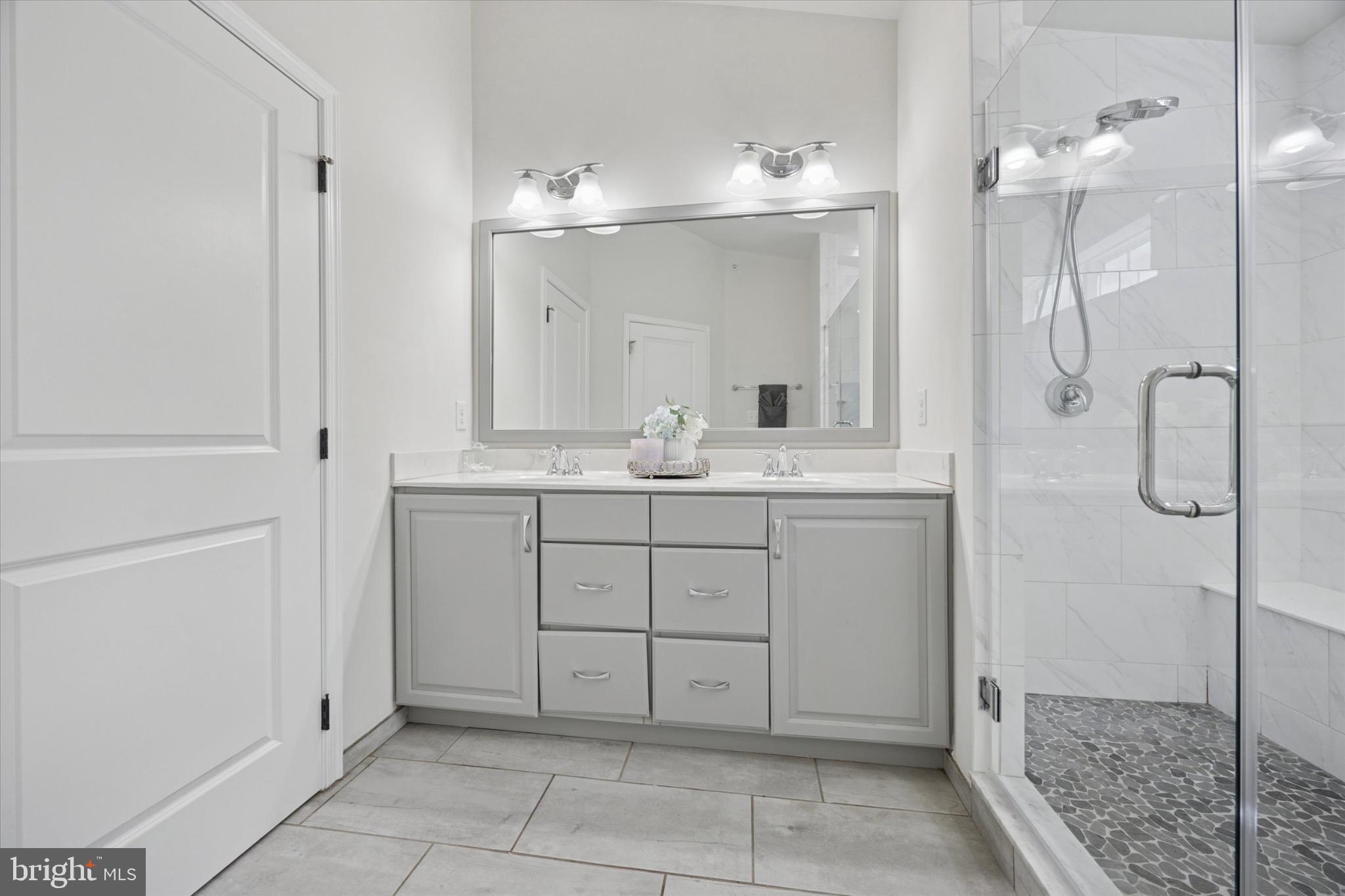 213 Corvus Circle Media, PA 19063 - Photo 16 of 34 a bathroom with a double vanity sink and a mirror