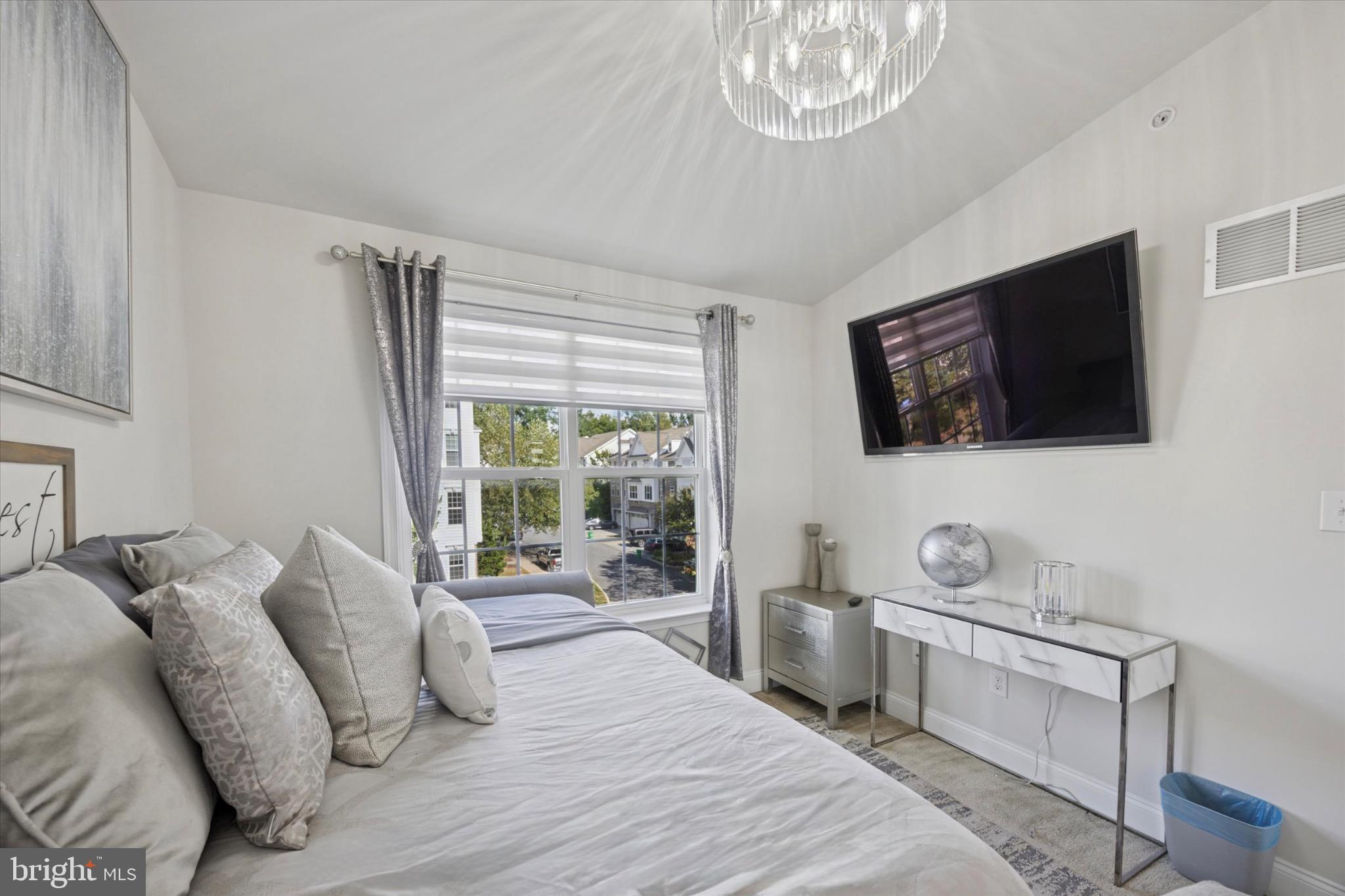 213 Corvus Circle Media, PA 19063 - Photo 19 of 34 a living room with furniture a flat screen tv and a floor to ceiling window