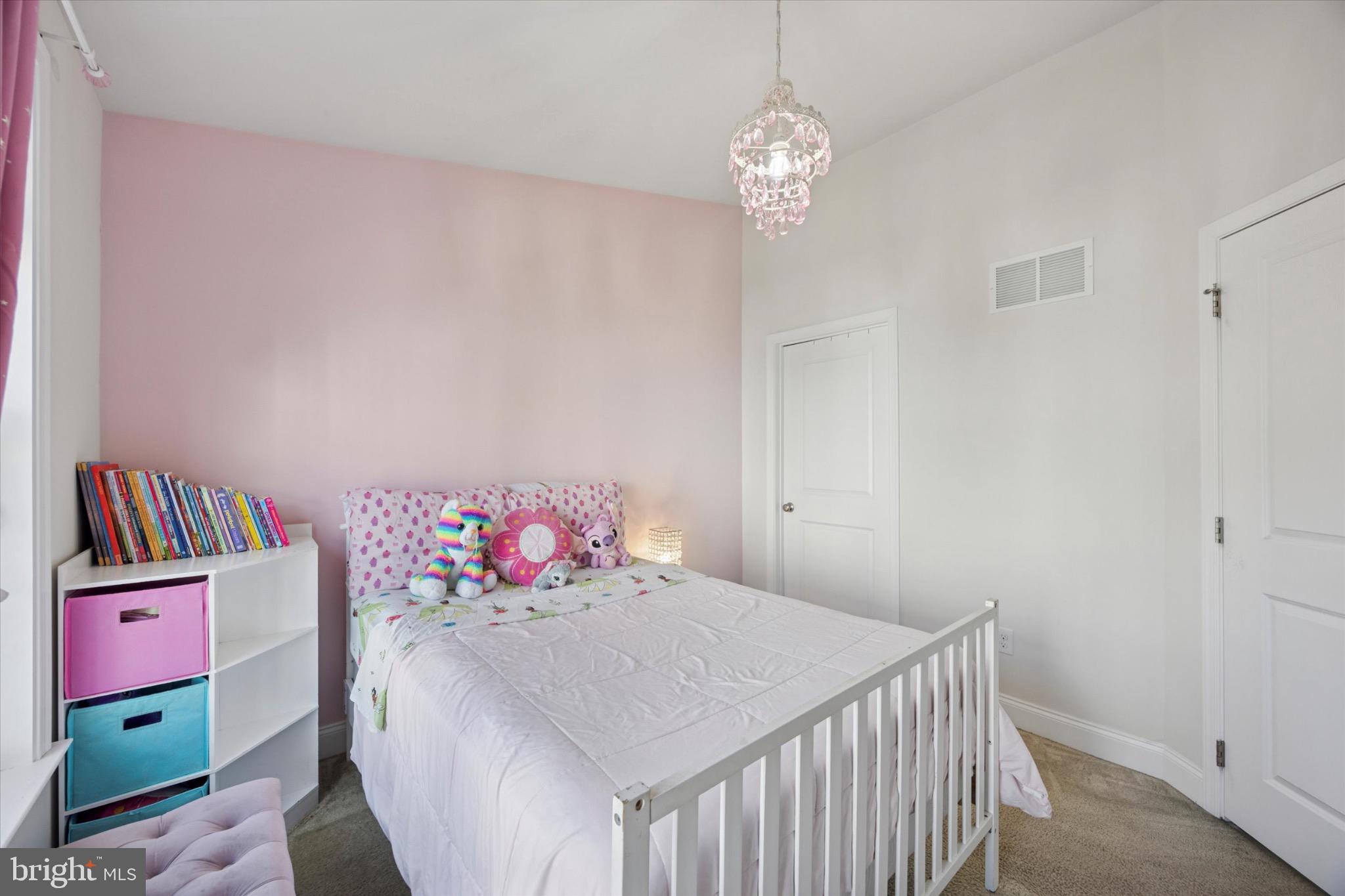 213 Corvus Circle Media, PA 19063 - Photo 22 of 34 a bedroom with a bed and a chandelier
