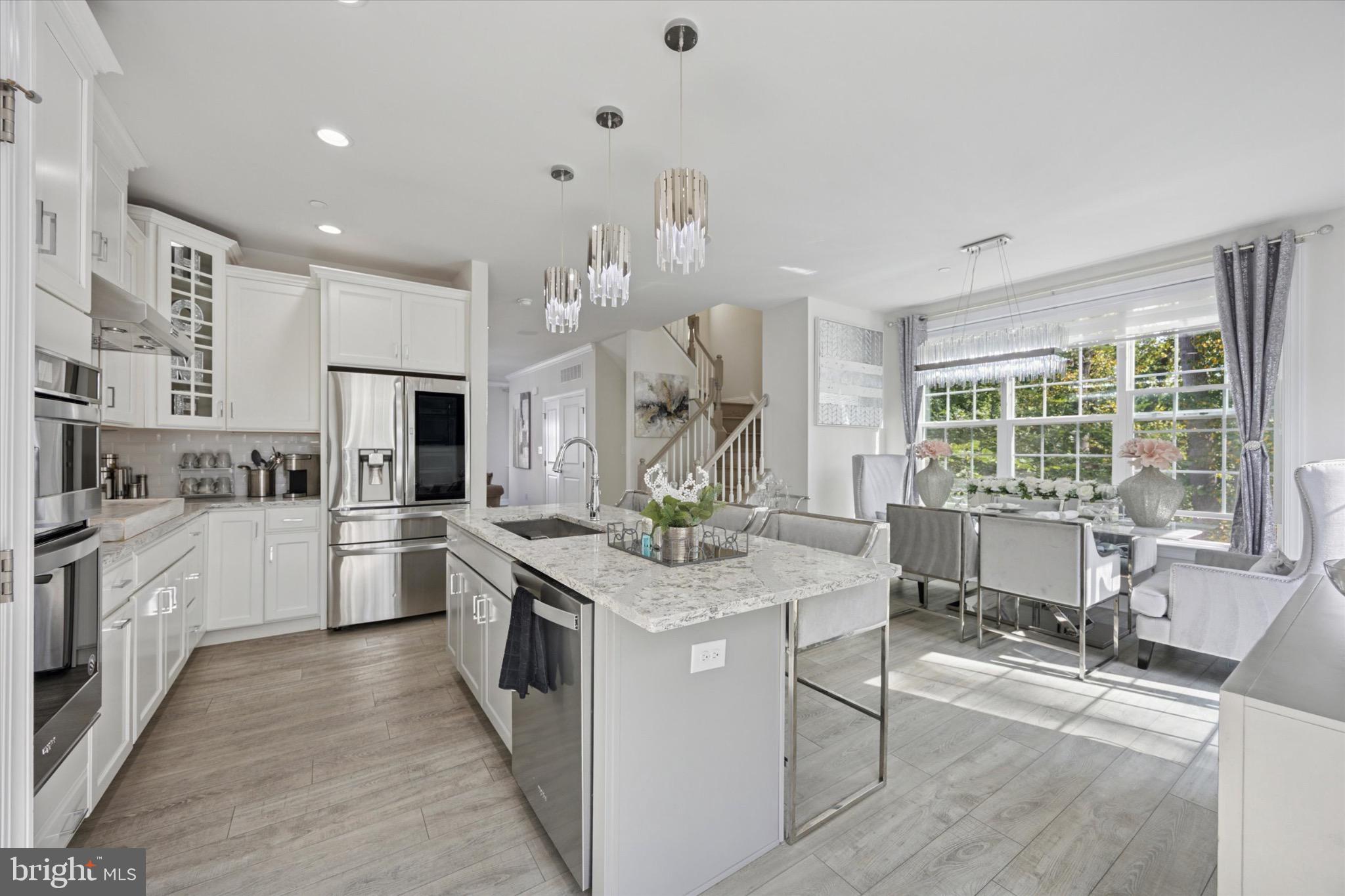 213 Corvus Circle Media, PA 19063 - Photo 6 of 34 a kitchen that has a lot of white cabinets and wooden floor
