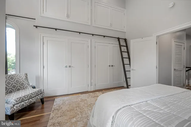 a bedroom with a bed and a couch