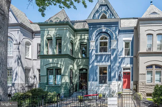 a front view of a residential houses with yard