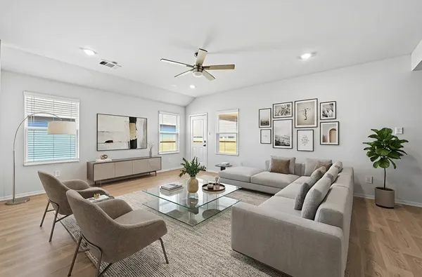 a living room with furniture and wooden floor