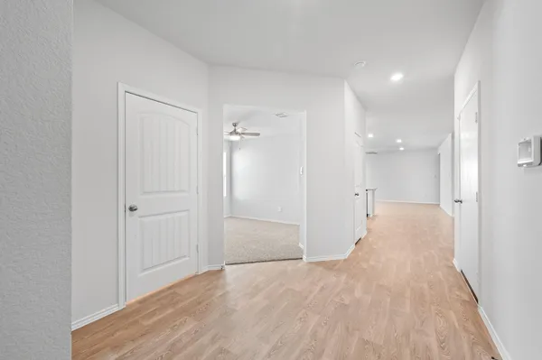 a view of a big room with wooden floor and bathroom