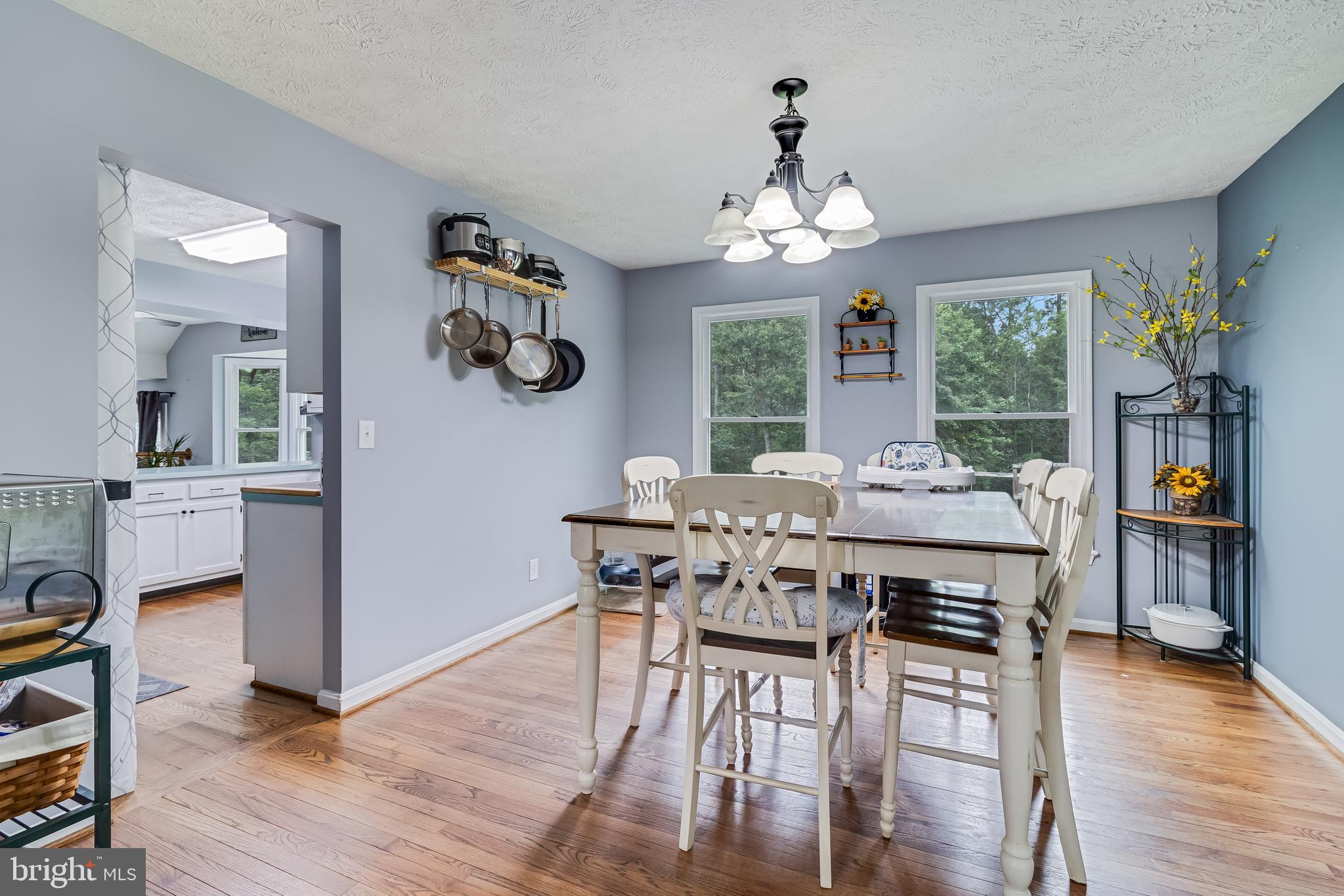 20919 Ridge Path Way Leonardtown, MD 20650 - Photo 11 of 56 a view of a dining room with furniture a chandelier and wooden floor