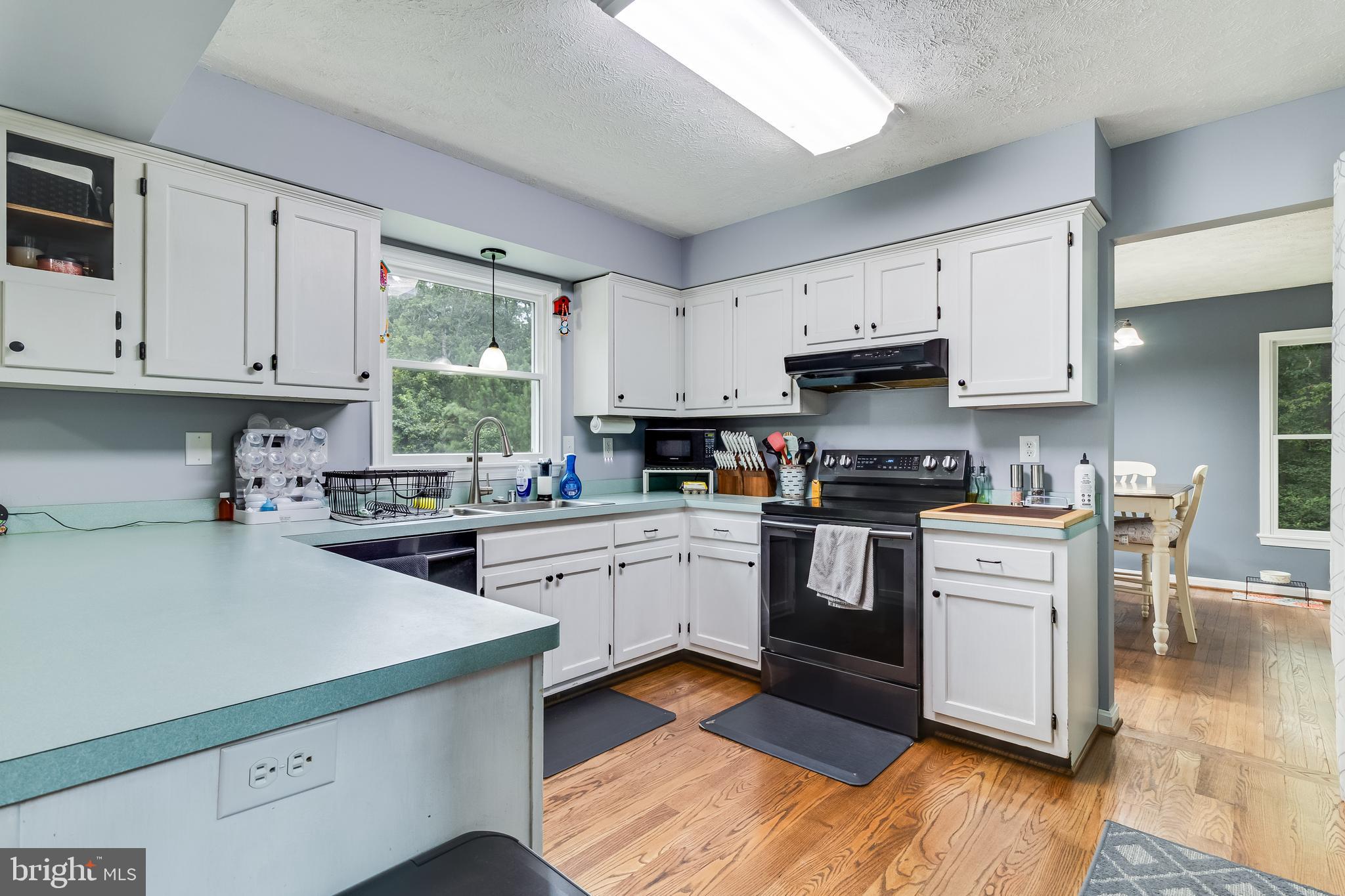 20919 Ridge Path Way Leonardtown, MD 20650 - Photo 30 of 56 a kitchen with granite countertop a sink cabinets stainless steel appliances and a window