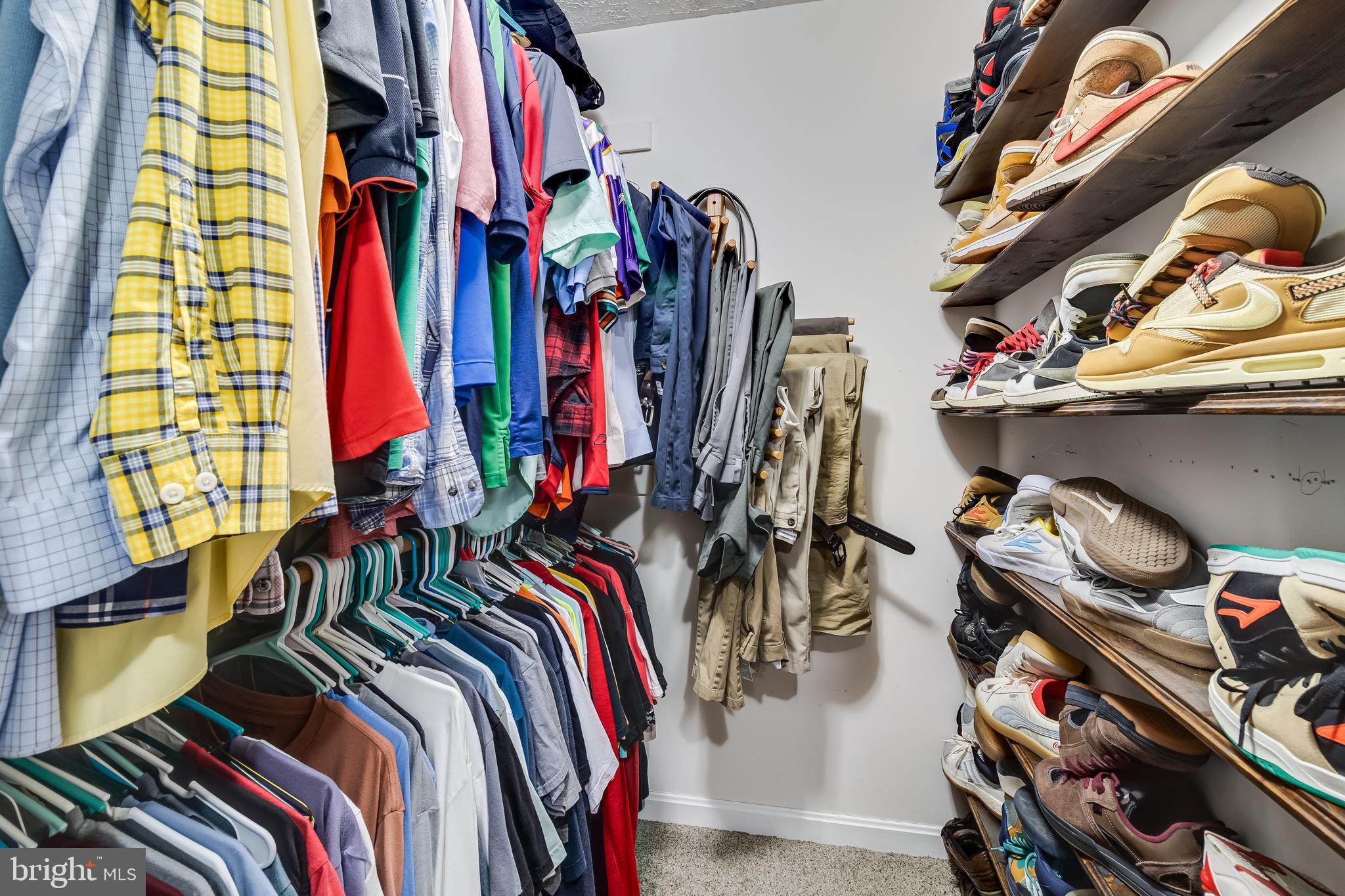 20919 Ridge Path Way Leonardtown, MD 20650 - Photo 36 of 56 a view of walk in closet with clothes and shoes