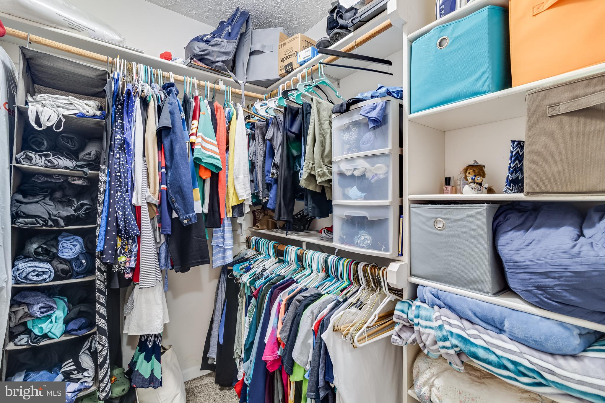 20919 Ridge Path Way Leonardtown, MD 20650 - Photo 43 of 56 a view of walk in closet with clothes and shoes
