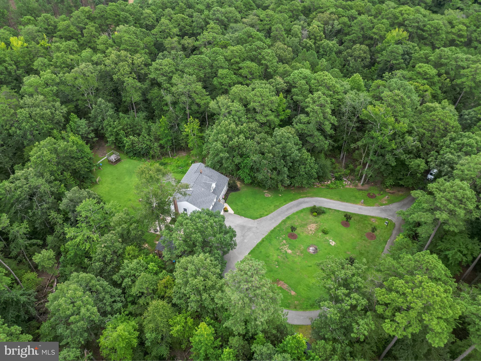20919 Ridge Path Way Leonardtown, MD 20650 - Photo 51 of 56 a view of a forest with a sink and bench