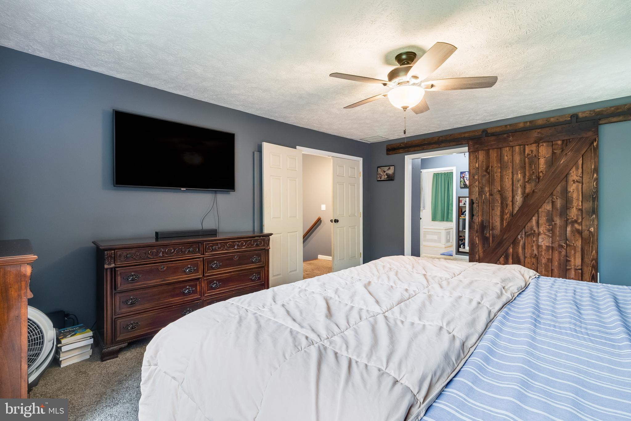 20919 Ridge Path Way Leonardtown, MD 20650 - Photo 56 of 56 a bedroom with a bed and a flat screen tv