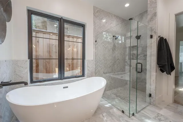 a bathroom with a bathtub and a shower