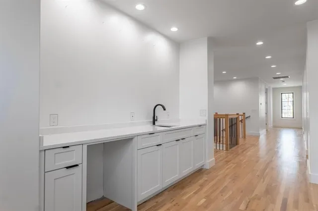 a view of a kitchen with a sink and a stove top oven