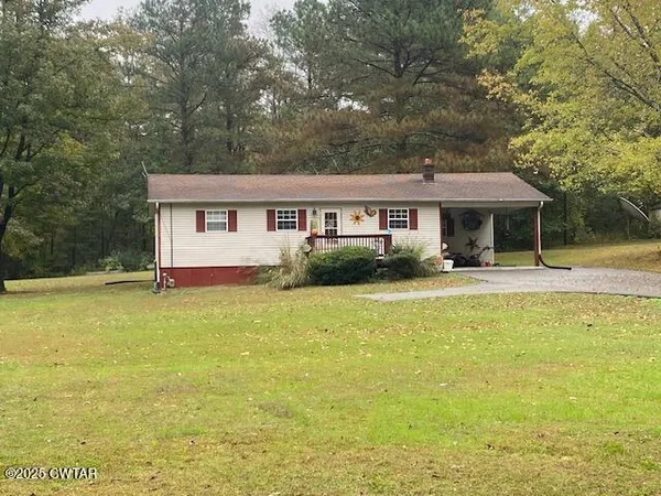 a front view of house with yard and outdoor seating