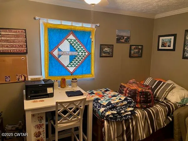 a bedroom with a bed and a desk