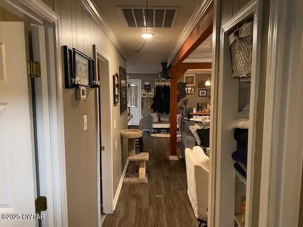 a view of a hallway with living room and furniture