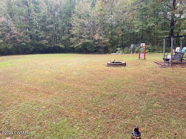 1885 Blue Goose Road Huron, TN 38345 - Photo 19 of 31 a view of a swimming pool with lawn chairs and palm trees