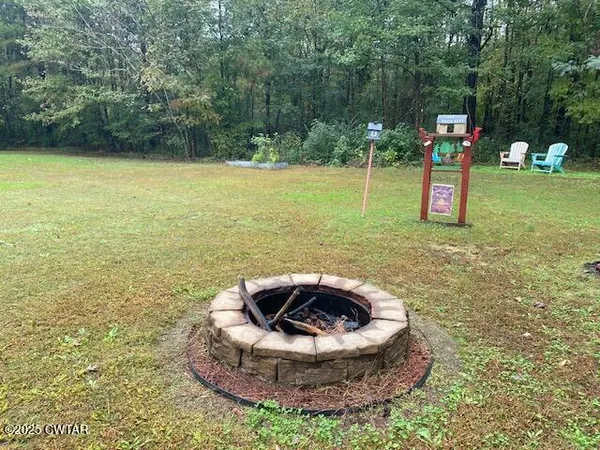 a view of a swimming pool and fire pit