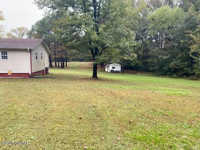 a view of a pool with a yard