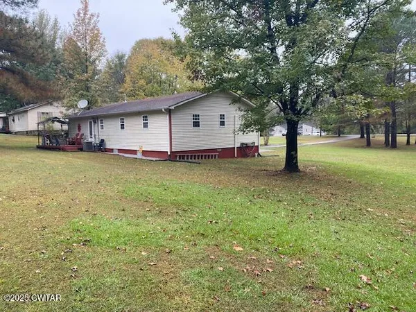 a house with a tree in the grass
