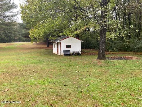 a big house with a big yard and large trees