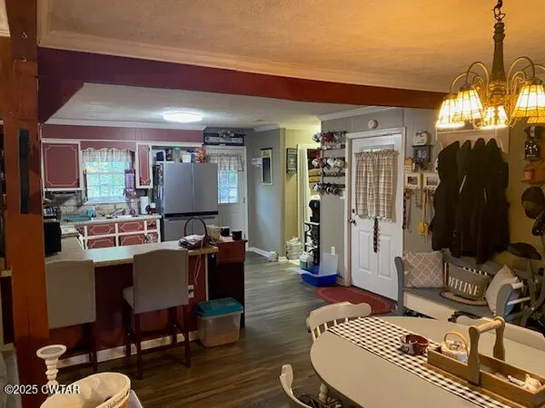 a living room with furniture a rug and a chandelier