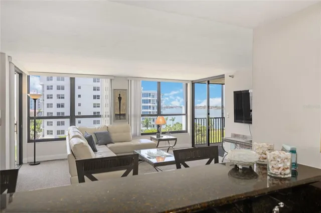 a living room with furniture and large windows