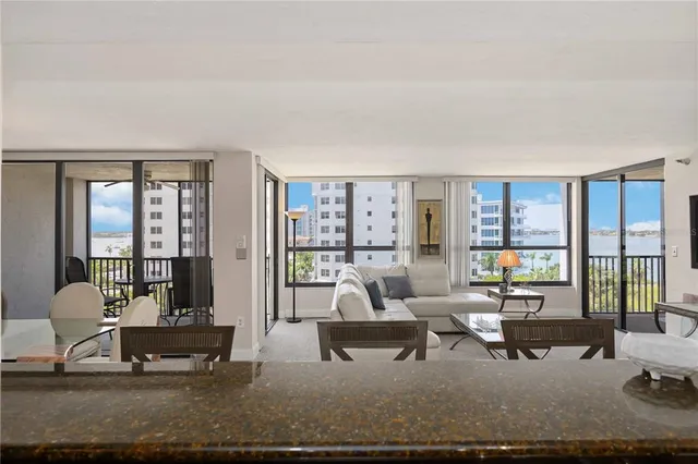 a living room with furniture and large windows