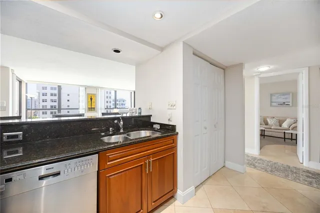 a kitchen with granite countertop a sink and a stove