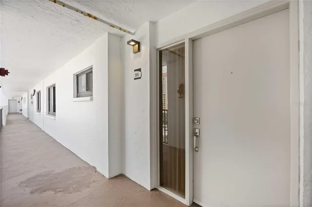 a view of a hallway with closet and front door