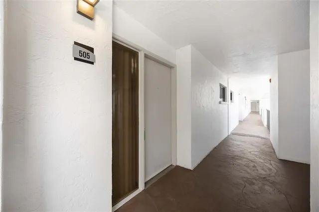 a view of a hallway with a white walls