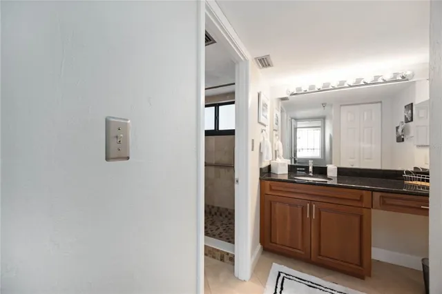 a kitchen with granite countertop a sink and cabinets