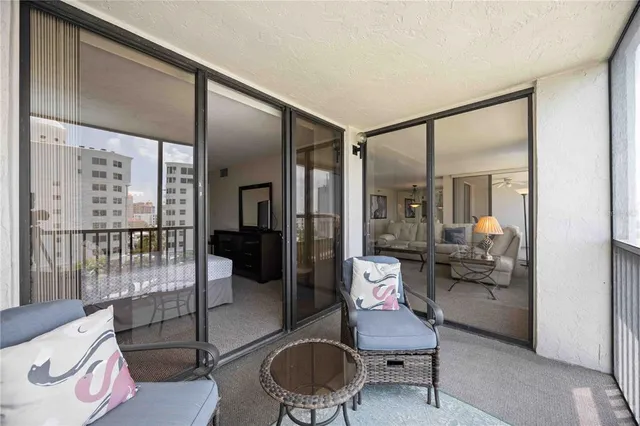 a living room with furniture and a floor to ceiling window