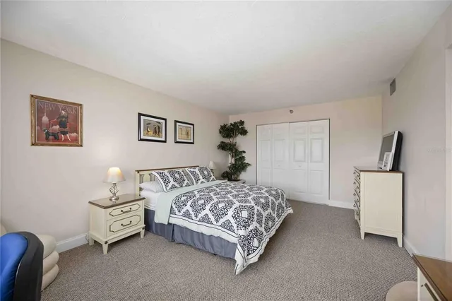 a bedroom with a bed and a couch