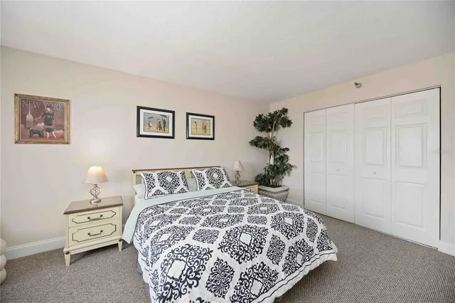 a bedroom with a bed and a painting on the wall