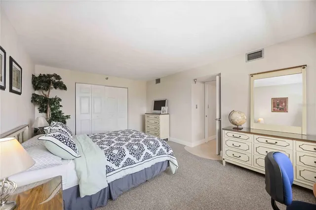 a bedroom with a bed and a dresser