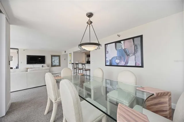 a dining room with furniture and a chandelier