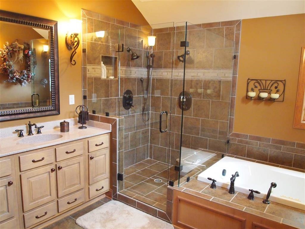 830 Big Bear Creek Road Cherokee, MS 35616 - Photo 30 of 39 Bathroom featuring vanity, plus walk in shower, vaulted ceiling, and tile patterned floors