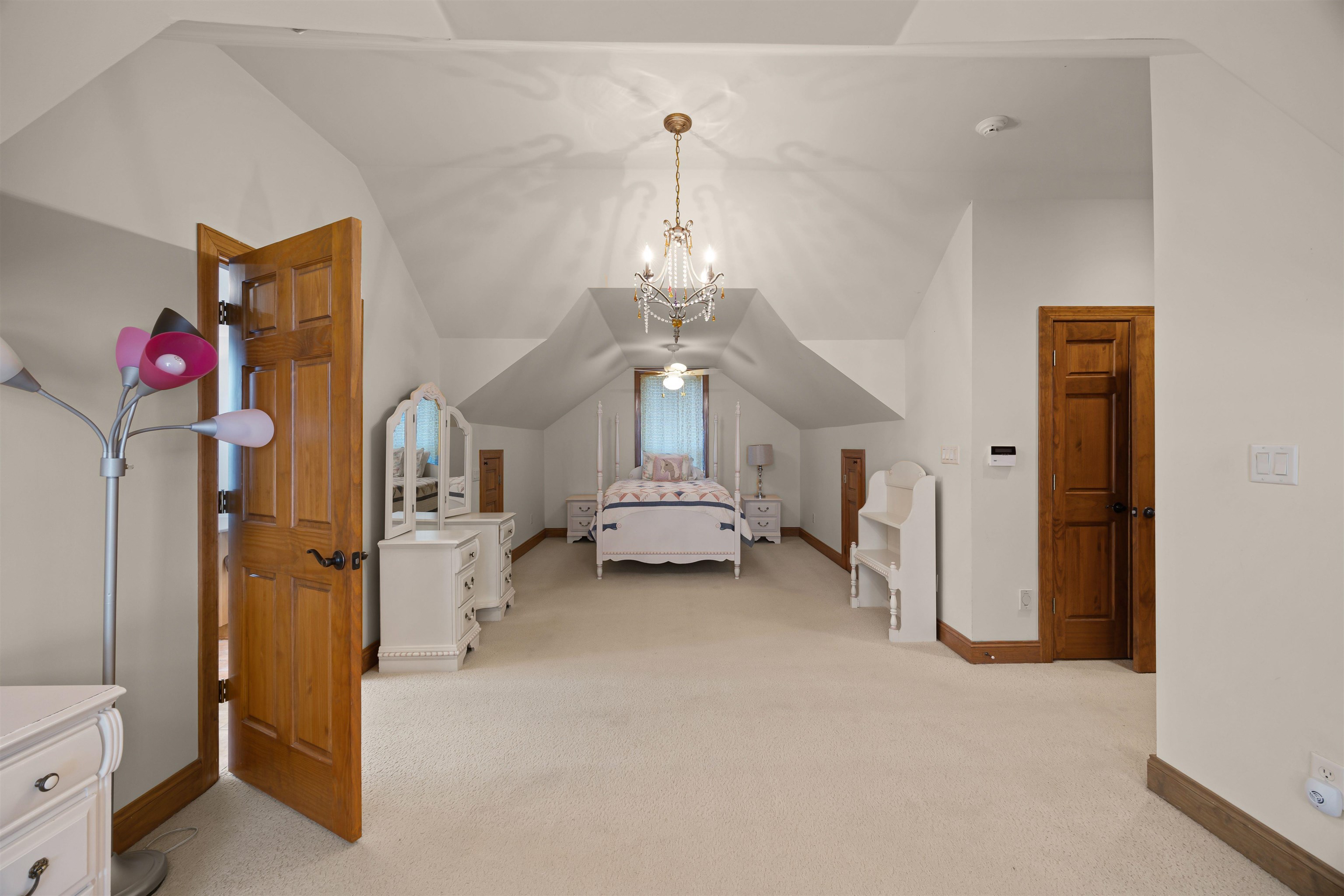 830 Big Bear Creek Road Cherokee, MS 35616 - Photo 31 of 39 Bedroom featuring light carpet, lofted ceiling, and an inviting chandelier