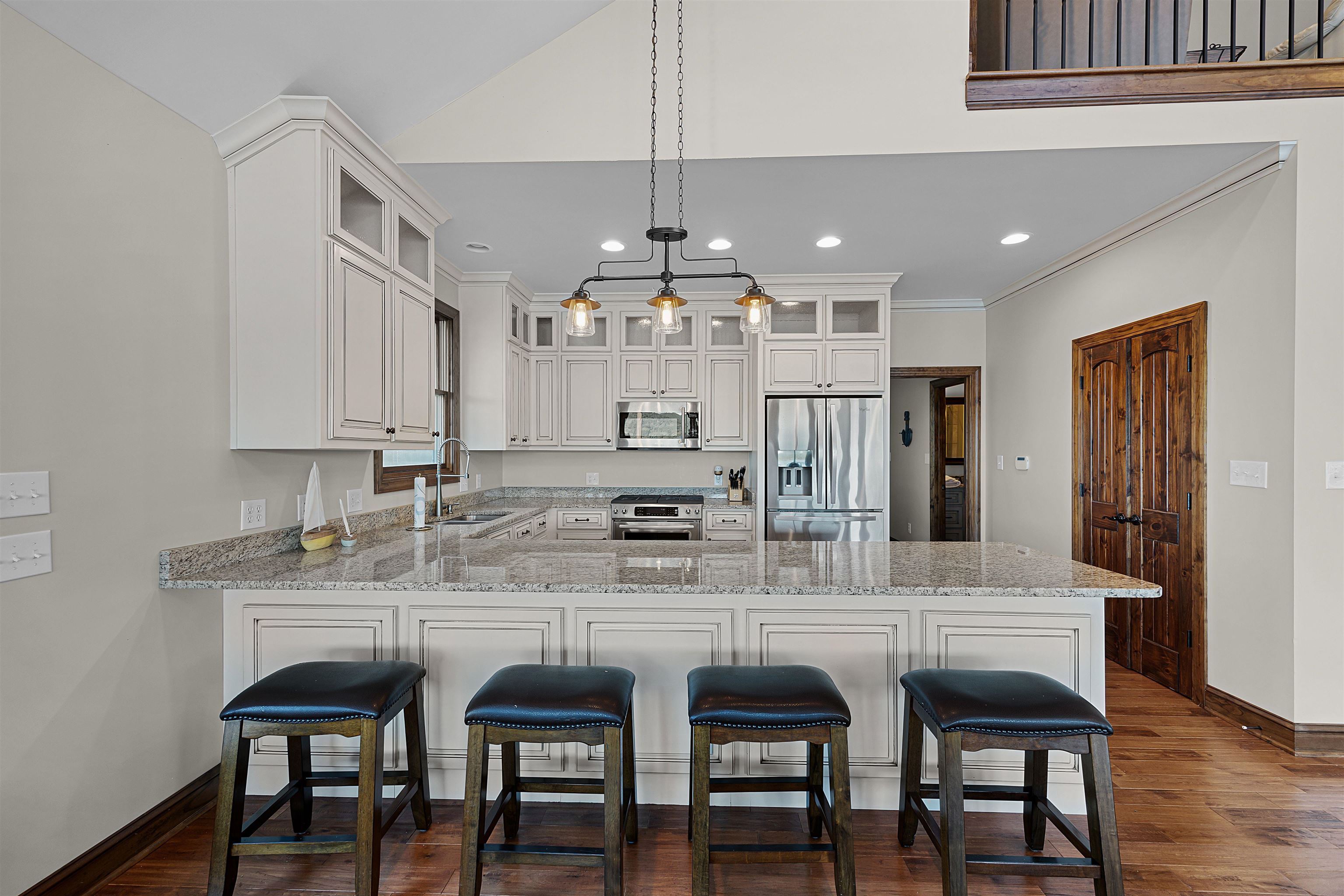 830 Big Bear Creek Road Cherokee, MS 35616 - Photo 10 of 39 Kitchen featuring white cabinets, sink, kitchen peninsula, decorative light fixtures, and appliances with stainless steel finishes