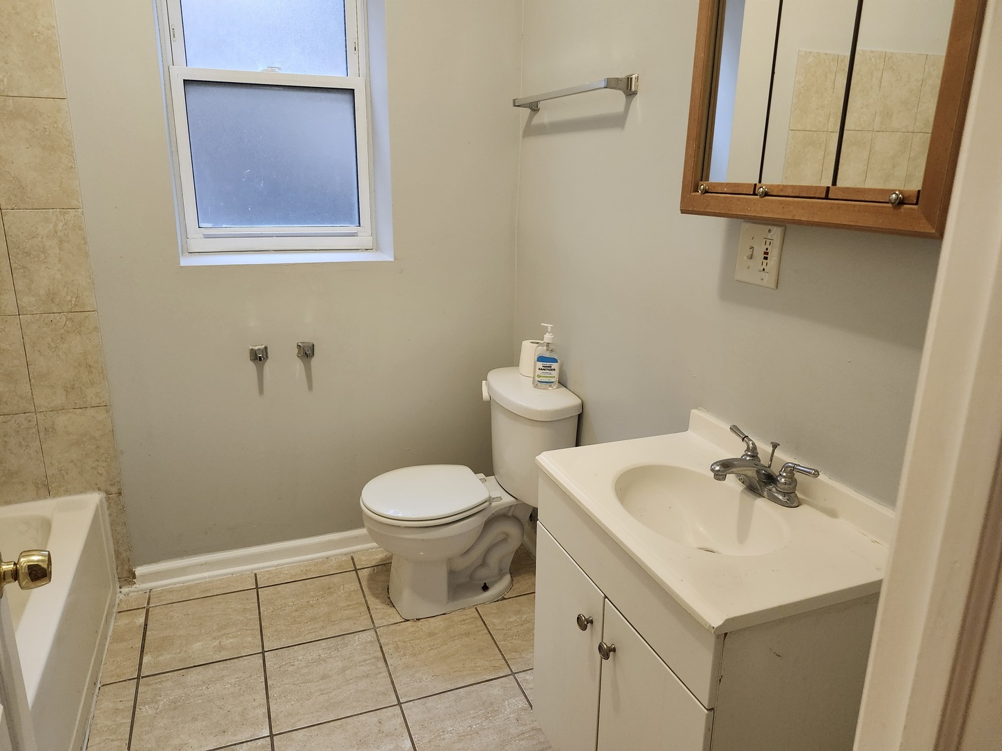 8016 South Ingleside Avenue, Unit 2S Chicago, IL 60619 - Photo 2 of 8 a bathroom with a sink a toilet and a mirror