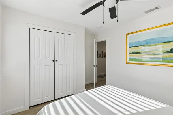 a bedroom with a bed and hallway