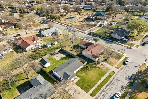 an aerial view of a residential houses with outdoor space
