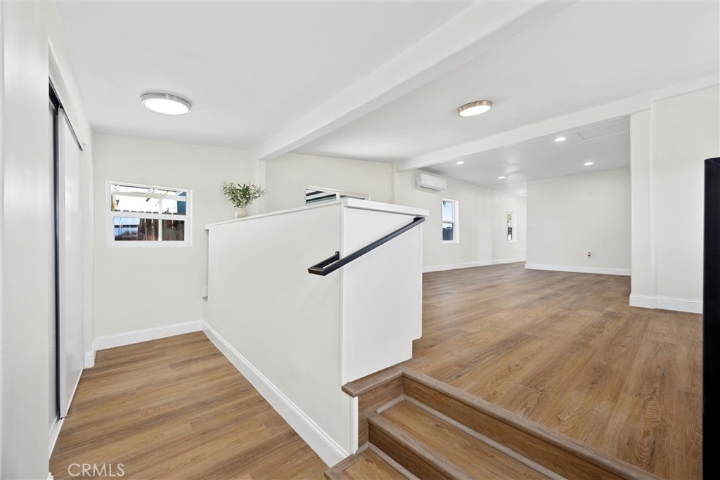 102 Jackson Street Taft, CA 93268 - Photo 15 of 34 a view of a hallway with wooden floor and staircase